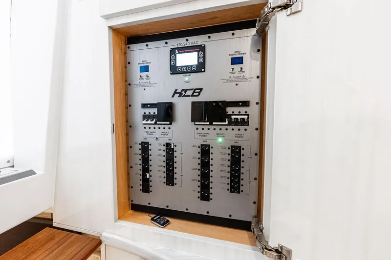 Slide: The Image of Electrical panel of 2025 HCB 56 Suenos GIX boat, showcasing control switches and indicators. - 28