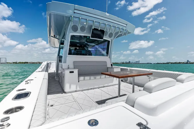Slide: The Image of Luxury HCB 56 Suenos GIX yacht, 2025 model, with spacious deck and seating, on open water. - 56