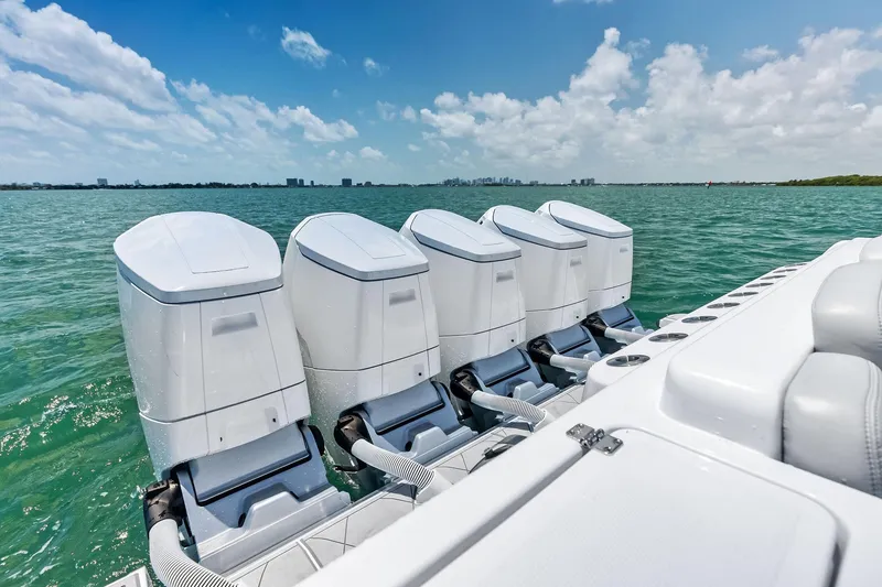 Slide: The Image of 2025 HCB 56 Suenos GIX boat with five powerful outboard engines on open water. - 57