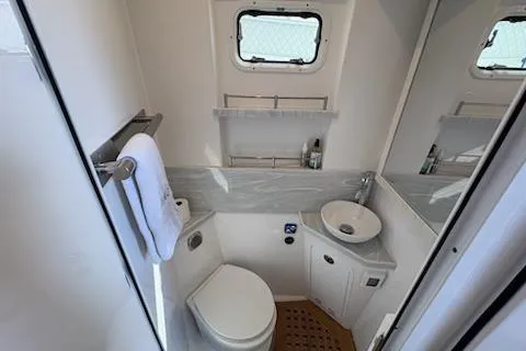 Slide: The Image of 2025 HCB 56 Suenos GIX yacht bathroom with modern fixtures and compact design. - 63