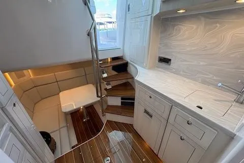 Slide: The Image of Luxurious interior of 2025 HCB 56 Suenos GIX yacht with modern kitchen and seating area. - 65