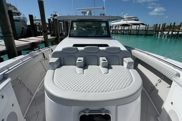 Slide: The Image of 2025 HCB 56 Suenos GIX luxury yacht with plush seating at a marina. - 69