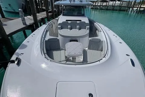 Slide: The Image of 2025 HCB 56 Suenos GIX luxury boat docked in clear turquoise water. - 70