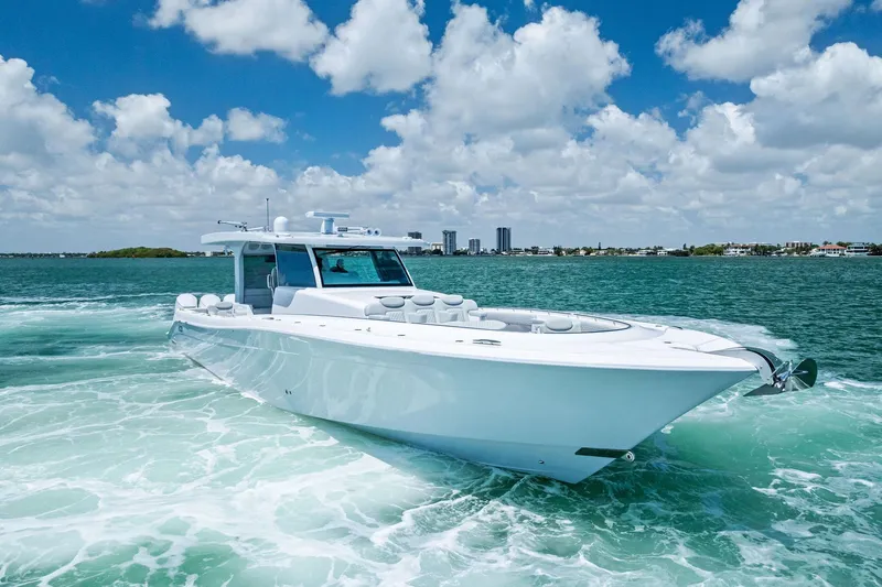 Slide: The Image of 2025 HCB 56 Suenos GIX luxury yacht cruising on clear blue waters. - 9