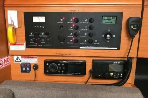 Slide: The Image of Control panel of a 2016 Jeanneau Sun Odyssey 419 sailboat, featuring navigation and communication equipment. - 7