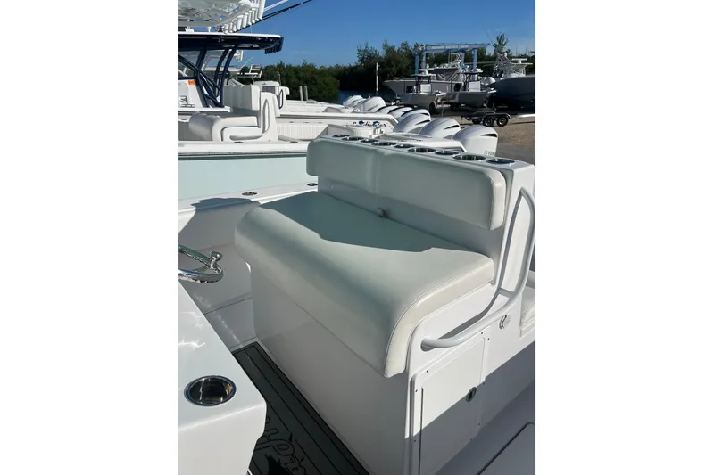 Slide: The Image of 2018 SeaHunter 31 Tournament boat with white cushioned seating and cup holders. - 7