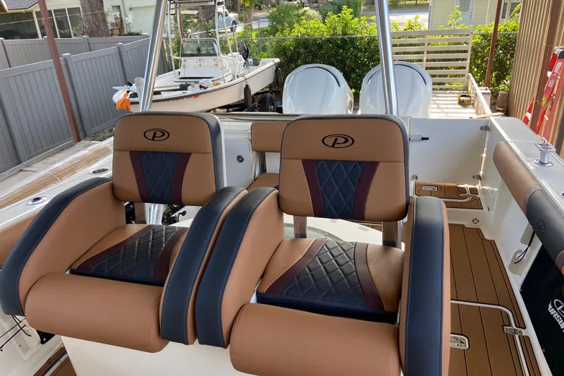 Slide: The Image of 2010 Pursuit C 280 Center Console boat with reflective maroon finish. - 11