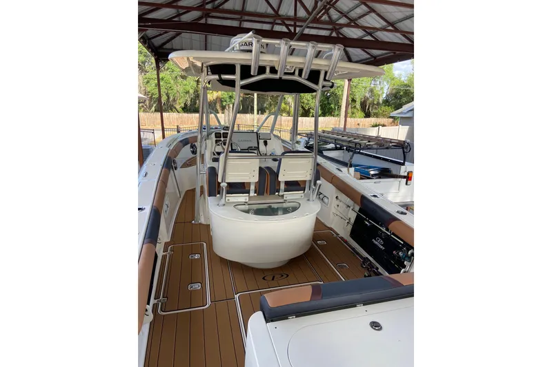 Slide: The Image of 2010 Pursuit C 280 Center Console boat dashboard with steering wheel and navigation controls. - 14