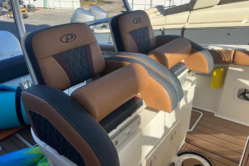 Slide: The Image of 2010 Pursuit C 280 Center Console boat seats with brown and black leather upholstery. - 20