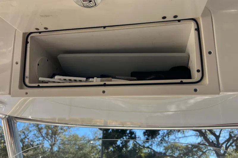 Slide: The Image of Open storage compartment on 2010 Pursuit C 280 Center Console boat. - 22