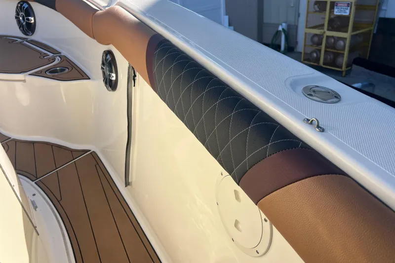 Slide: The Image of Interior of 2010 Pursuit C 280 Center Console boat with cushioned rail and speakers. - 23