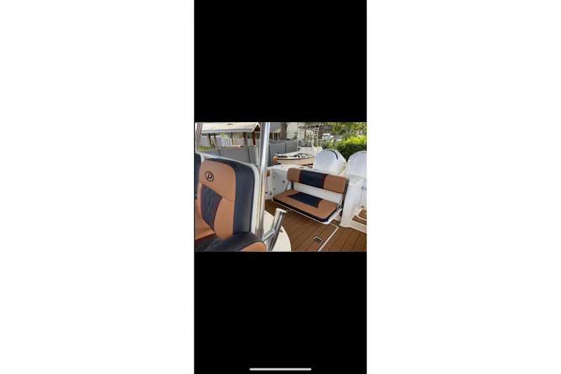 Slide: The Image of 2010 Pursuit C 280 Center Console boat with stylish seating and dual engines. - 4