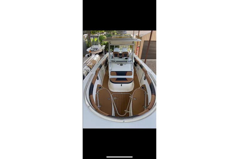 Slide: The Image of 2010 Pursuit C 280 Center Console boat with stylish leather seating and dual engines. - 5
