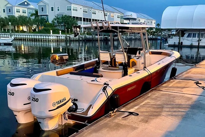 Slide: The Image of 2010 Pursuit C 280 Center Console boat with sleek design and spacious deck under a canopy. - 8