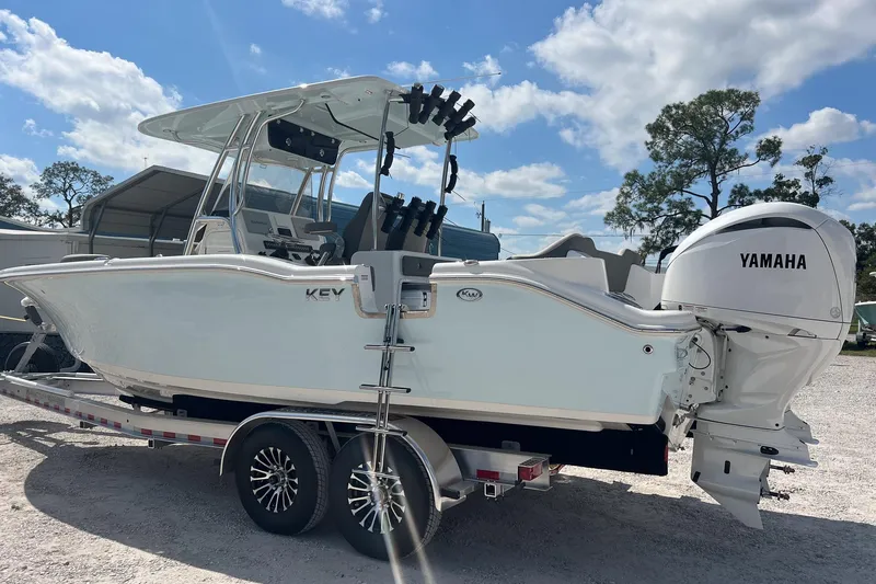 Slide: The Image of 2026 Key West 263 FS boat with Yamaha engine on a trailer, under a clear sky. - 10