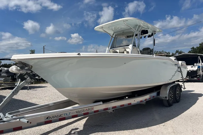 Slide: The Image of 2026 Key West 263 FS boat on trailer under blue sky. - 11