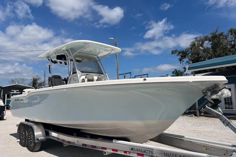 Slide: The Image of 2026 Key West 263 FS boat on trailer under blue sky. - 3