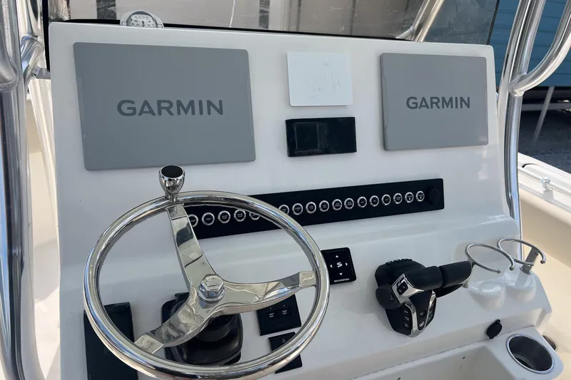 Slide: The Image of Key West 263 FS 2026 boat dashboard with Garmin displays and steering wheel. - 7