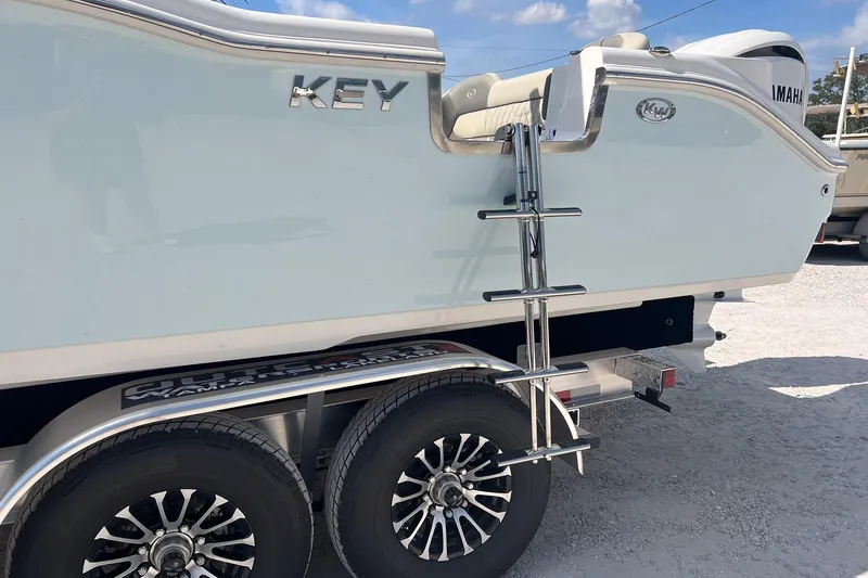Slide: The Image of 2026 Key West 263 FS boat on trailer with ladder and dual wheels. - 9