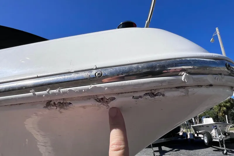 Slide: The Image of 2005 Sea Fox 197 Center Console with visible hull damage and finger pointing. - 10