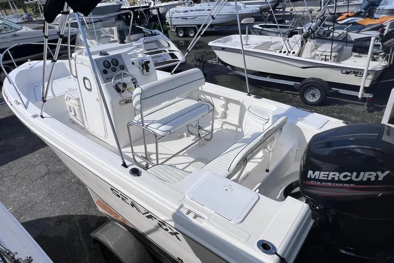 Slide: The Image of 2005 Sea Fox 197 Center Console boat with Mercury engine, docked in a marina. - 14