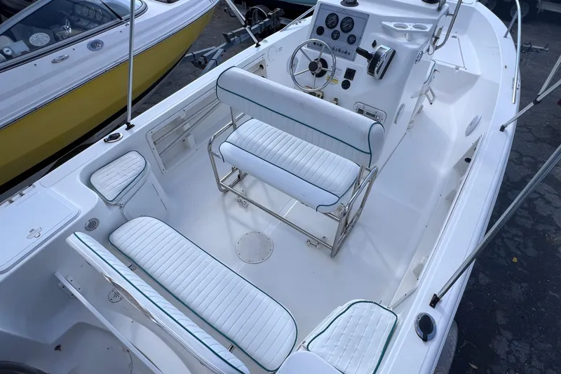 Slide: The Image of 2005 Sea Fox 197 Center Console boat interior with white seating and control panel. - 16