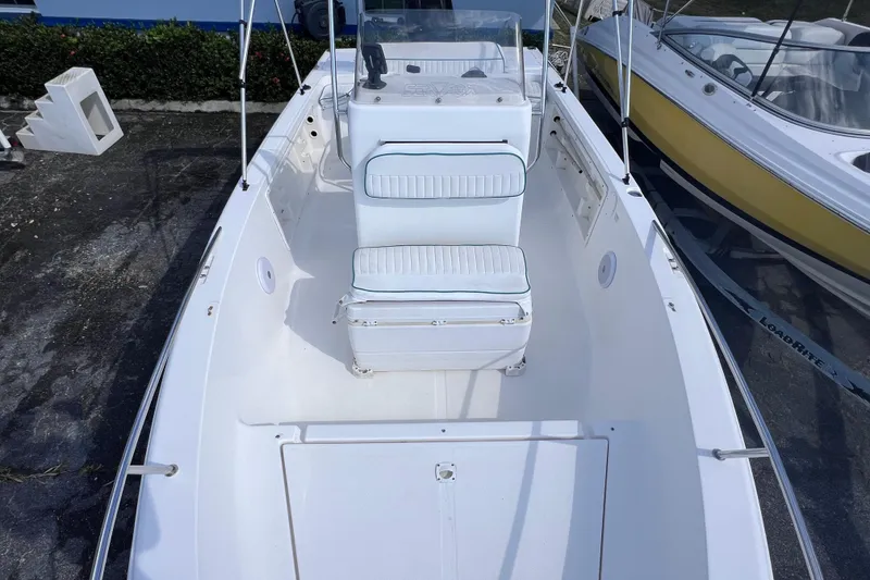 Slide: The Image of 2005 Sea Fox 197 Center Console boat with white seating and console, docked outdoors. - 19