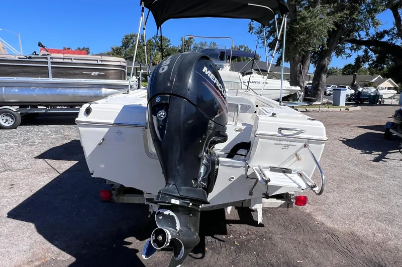 Slide: The Image of 2005 Sea Fox 197 Center Console boat with Mercury outboard motor in a marina. - 2