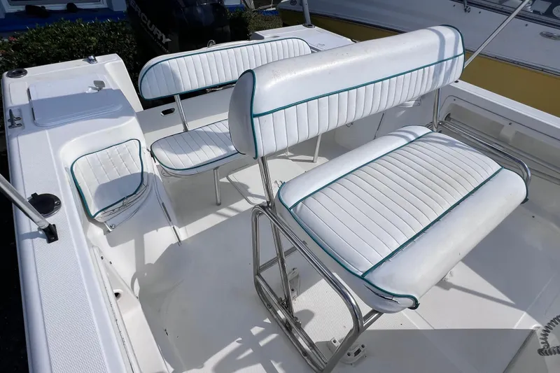 Slide: The Image of 2005 Sea Fox 197 Center Console boat interior with white cushioned seating. - 20