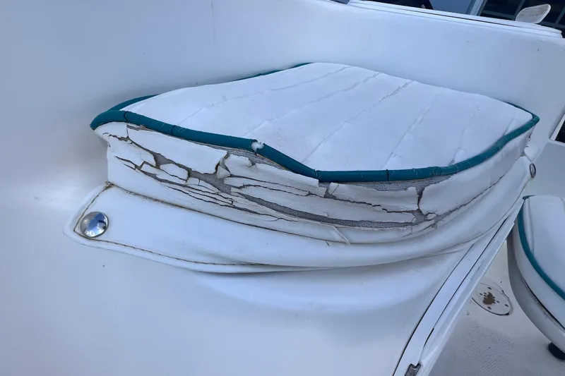 Slide: The Image of Worn seat cushion on 2005 Sea Fox 197 Center Console boat, showing cracked upholstery. - 22