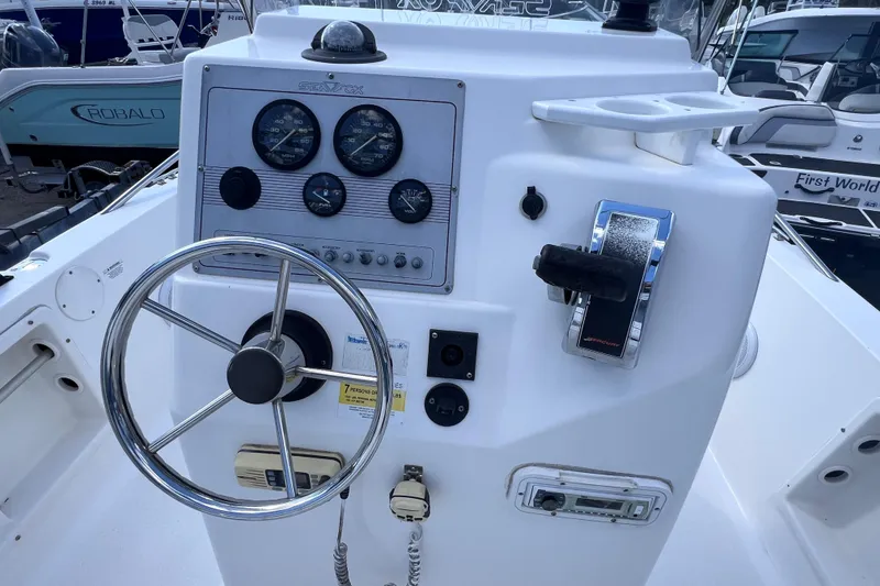 Slide: The Image of 2005 Sea Fox 197 Center Console dashboard with steering wheel and control panel. - 24