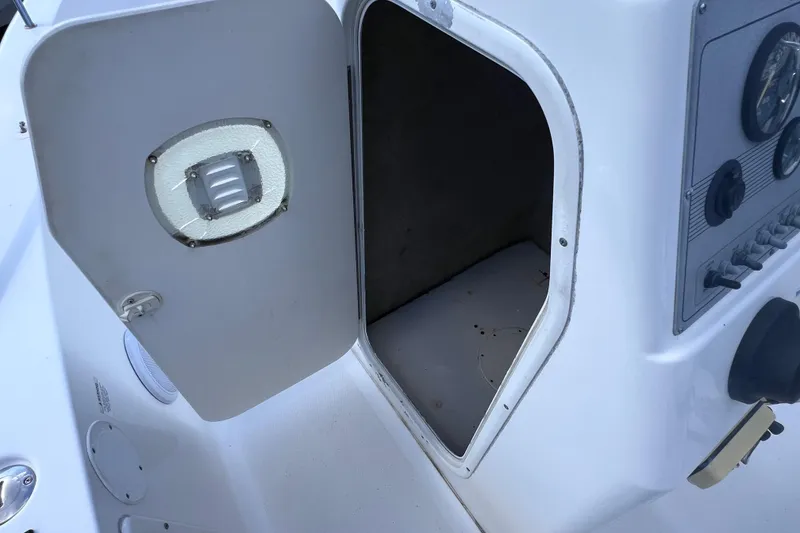 Slide: The Image of Open storage compartment on a 2005 Sea Fox 197 Center Console boat. - 27