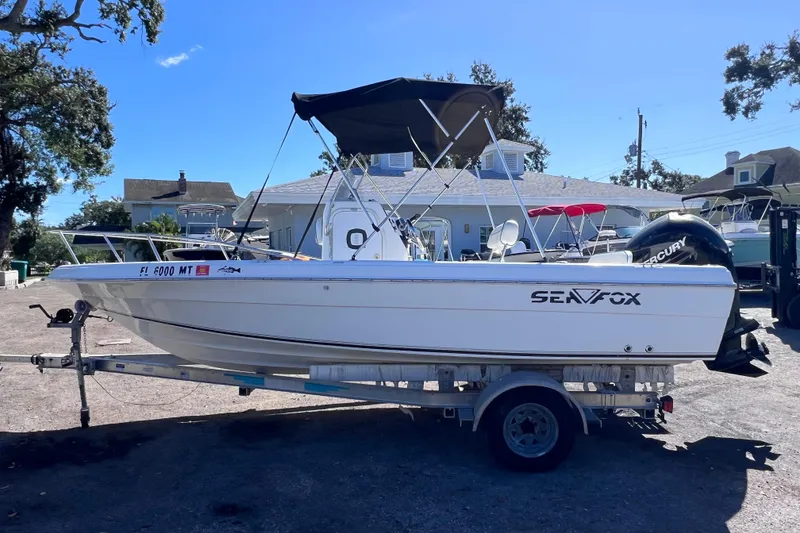 Slide: The Image of 2005 Sea Fox 197 Center Console boat on trailer, parked outdoors. - 5