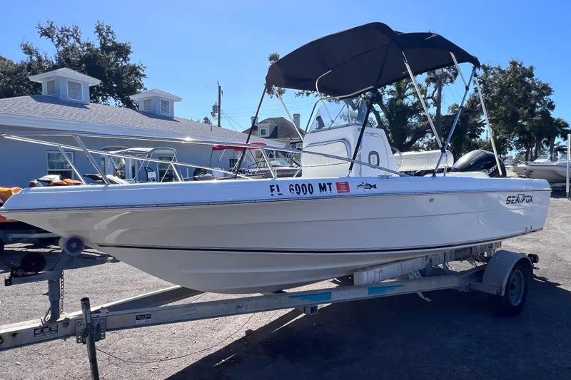 Slide: The Image of 2005 Sea Fox 197 Center Console boat on trailer, parked outdoors. - 6