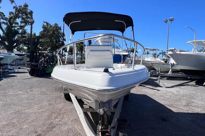 Slide: The Image of 2005 Sea Fox 197 Center Console boat on trailer, parked outdoors under clear blue sky. - 8