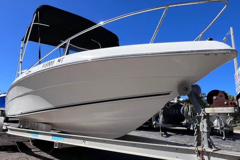 Slide: The Image of 2005 Sea Fox 197 Center Console boat on trailer, clear blue sky background. - 9
