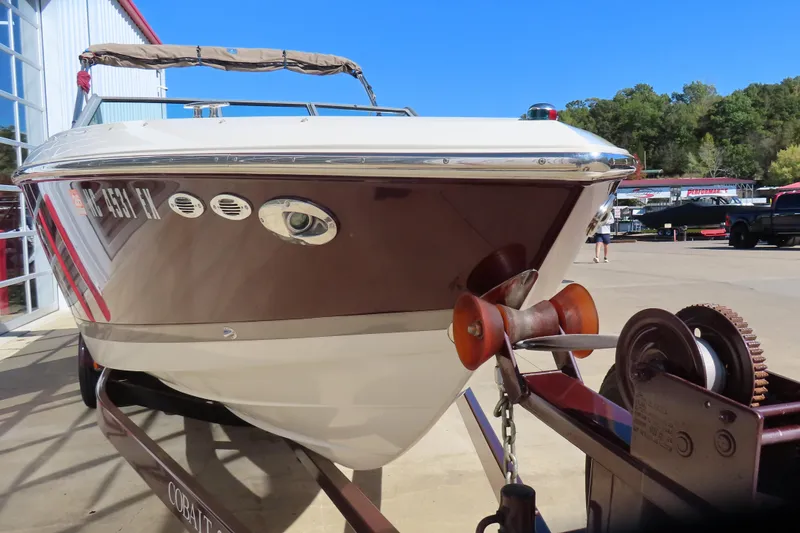 Slide: The Image of 2005 Cobalt 272 boat on trailer, parked outdoors near a building. - 12