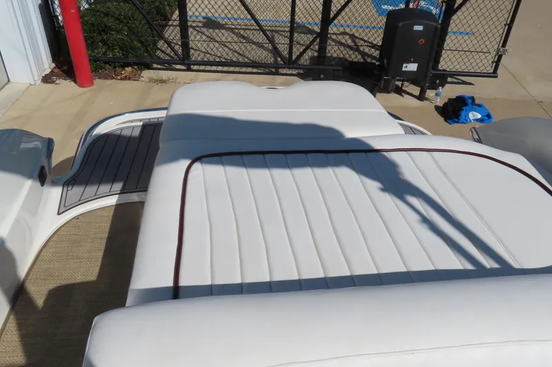 Slide: The Image of 2005 Cobalt 272 boat with white cushioned seating and outdoor setting. - 15