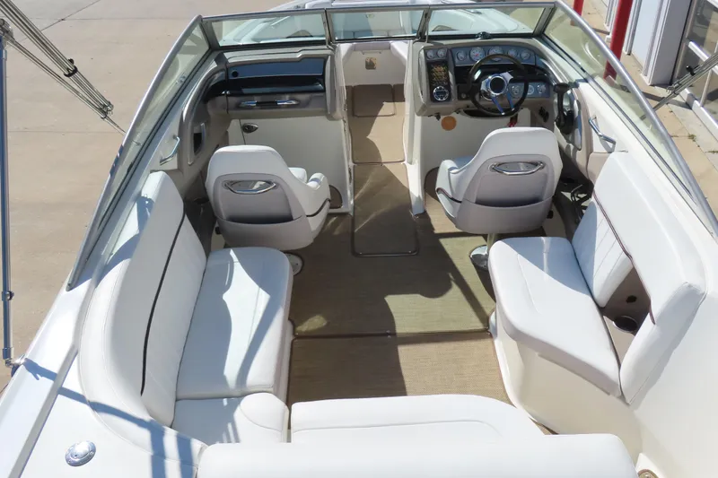Slide: The Image of 2005 Cobalt 272 boat interior with white seating and steering console. - 16