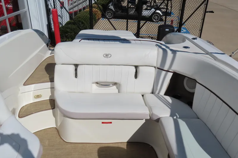 Slide: The Image of 2005 Cobalt 272 boat interior with white leather seating and beige flooring. - 17