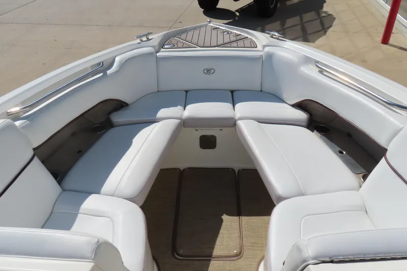 Slide: The Image of 2005 Cobalt 272 boat interior with white cushioned seating and stainless steel accents. - 19