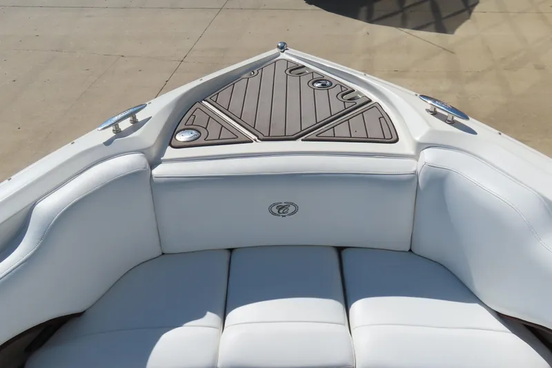 Slide: The Image of 2005 Cobalt 272 boat interior with white cushioned seating and wood accents. - 23