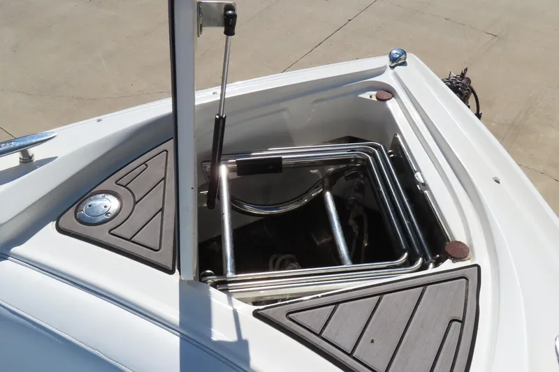 Slide: The Image of Open storage compartment on a 2005 Cobalt 272 boat, featuring stainless steel fittings. - 24