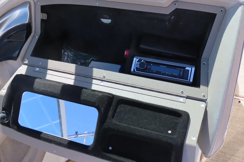 Slide: The Image of 2005 Cobalt 272 boat dashboard with stereo system and storage compartment. - 25