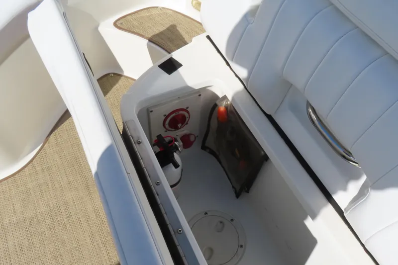 Slide: The Image of Storage compartment in a 2005 Cobalt 272 boat with fire extinguisher and safety equipment. - 27