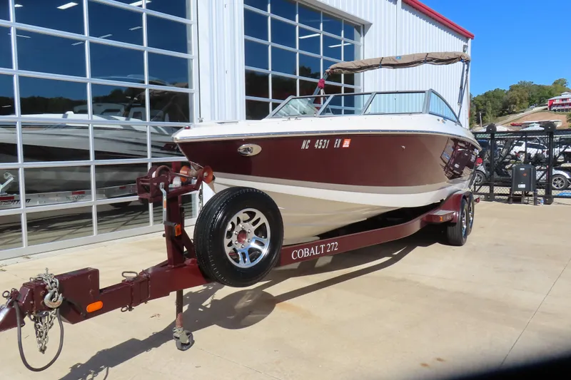 Slide: The Image of 2005 Cobalt 272 boat on trailer outside a showroom. - 3