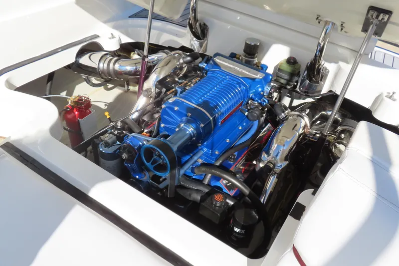 Slide: The Image of Engine compartment of a 2005 Cobalt 272 boat, featuring a blue engine and chrome components. - 5