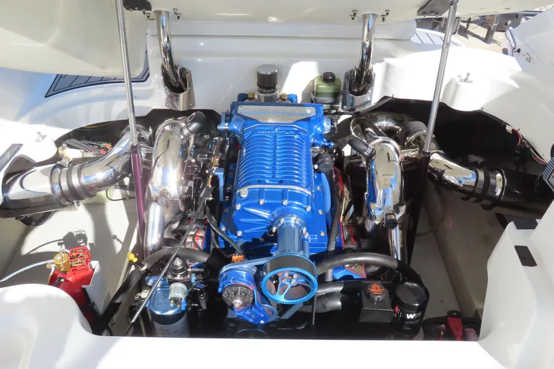 Slide: The Image of 2005 Cobalt 272 engine compartment with a blue supercharger and chrome exhaust components. - 6