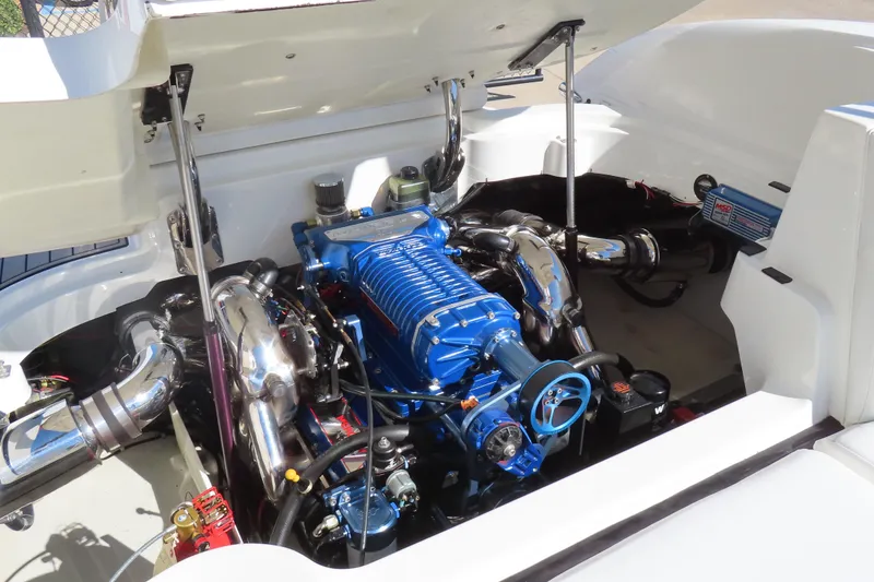 Slide: The Image of Engine compartment of a 2005 Cobalt 272 boat with a blue engine and chrome components. - 7