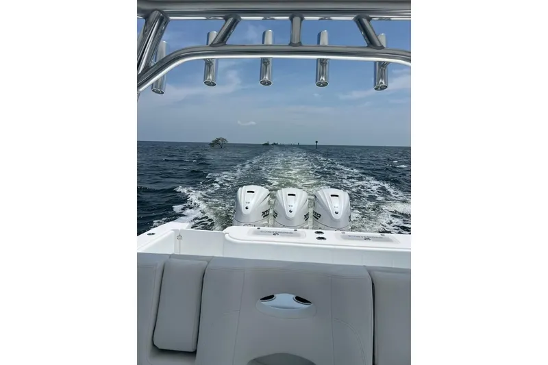 Slide: The Image of Contender 44 ST 2025 boat cruising on open water, showcasing powerful engines and sleek design. - 10